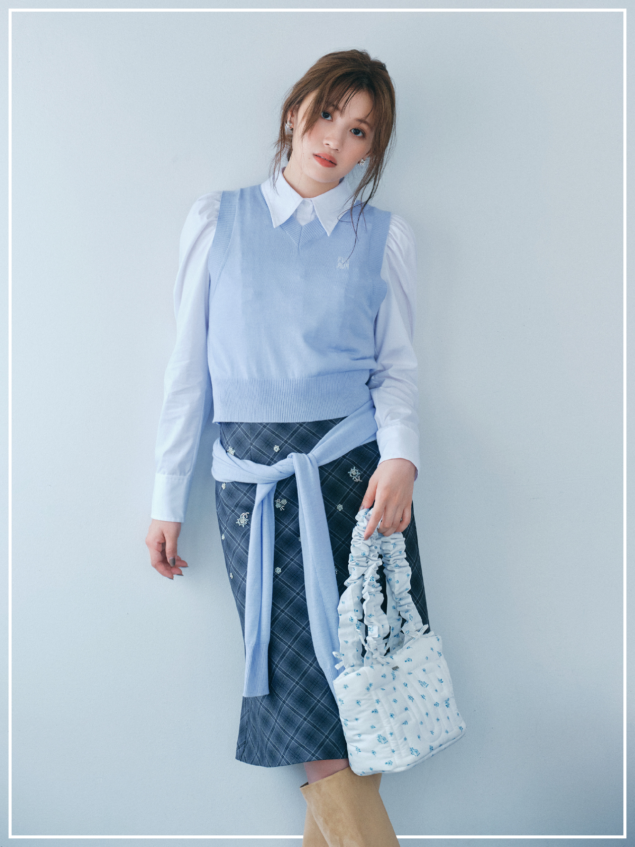 コンパクトパフスリーブシャツ・ボレロレイヤーベストセット・ビーズ刺繍ミディスカート・リサイクルシルバーピアス・リサイクルシルバーリング・【限定カラー】ロゴパデッドトートバッグ・ウエスタンロングブーツを着用した女性