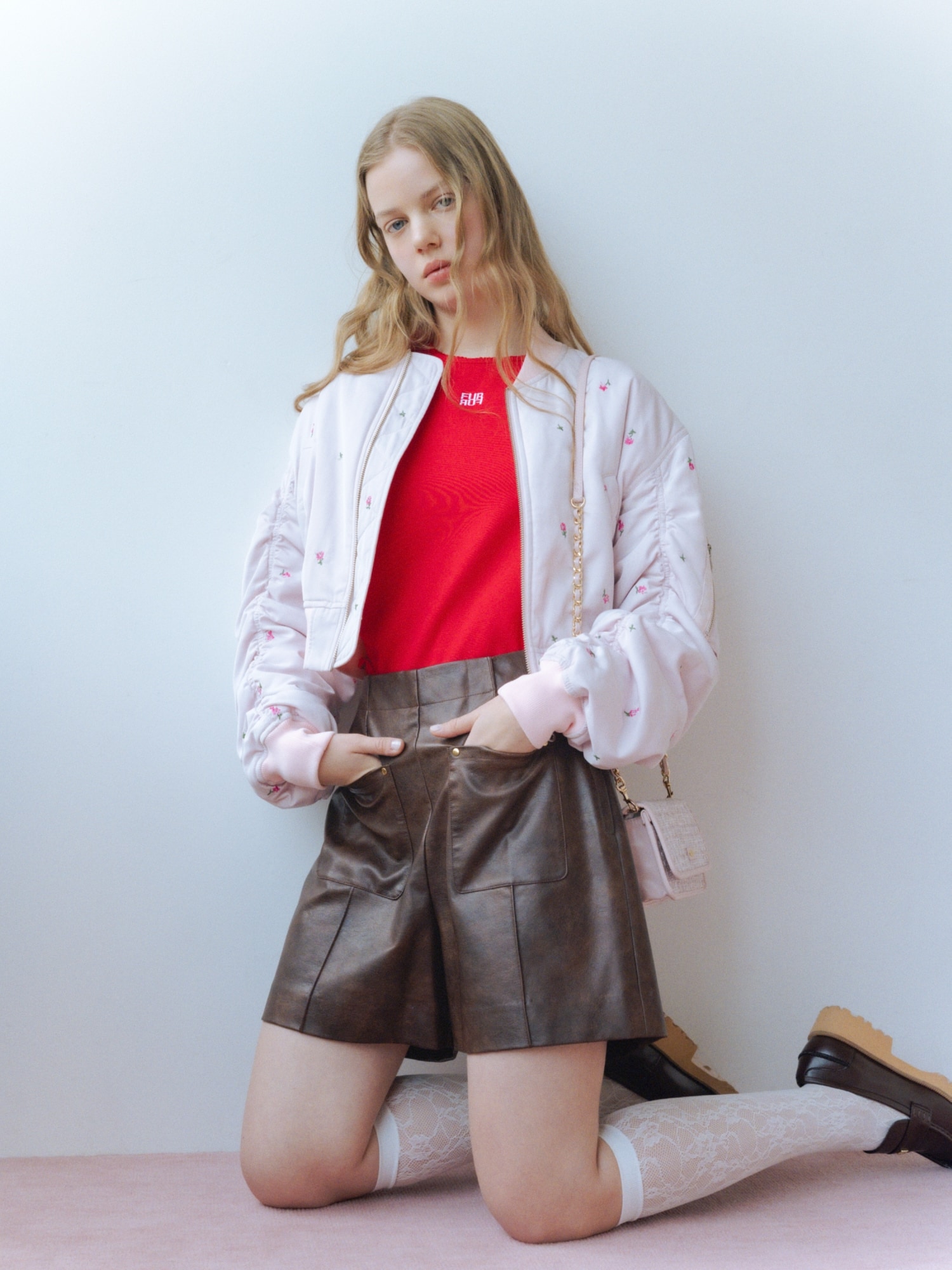 ピンクのフラワー刺繍ＭＡ−１・赤の５ｄａｙｓＴシャツ・ブラウンのレザーライクショートパンツ・ピンクのツイード×サテンビッグリボンキャップ・ピンクのツイードロゴフォンホルダー・ブラウンのミニリボンカシメローファーを合わせたコーディネート